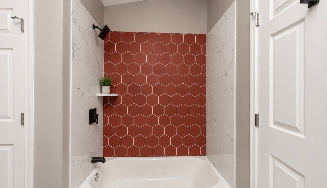 Finished bathroom remodel with terracotta tile shower wall and marble surround