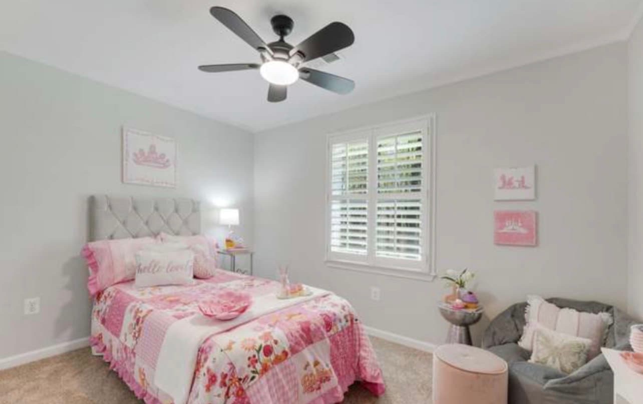 Refreshed bedroom with neutral walls, ceiling fan, and styled furnishings